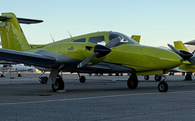 Piper Seminole, Cessna 162 and Piper trainers lined up on the Van Nuys Airport ramp at golden hour