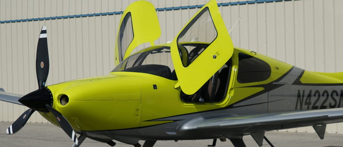 Cirrus SR22 Turbo with its gull-wing door open on the ramp at Van Nuys