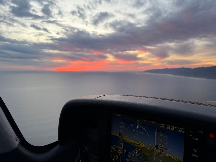 The glass panel at sunset with the coastline ahead