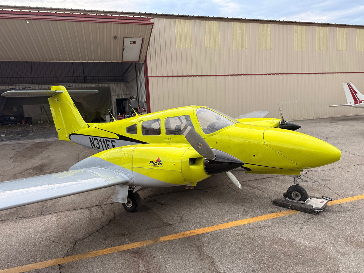 Piper Seminole N311EF, front quarter, before the open hangar