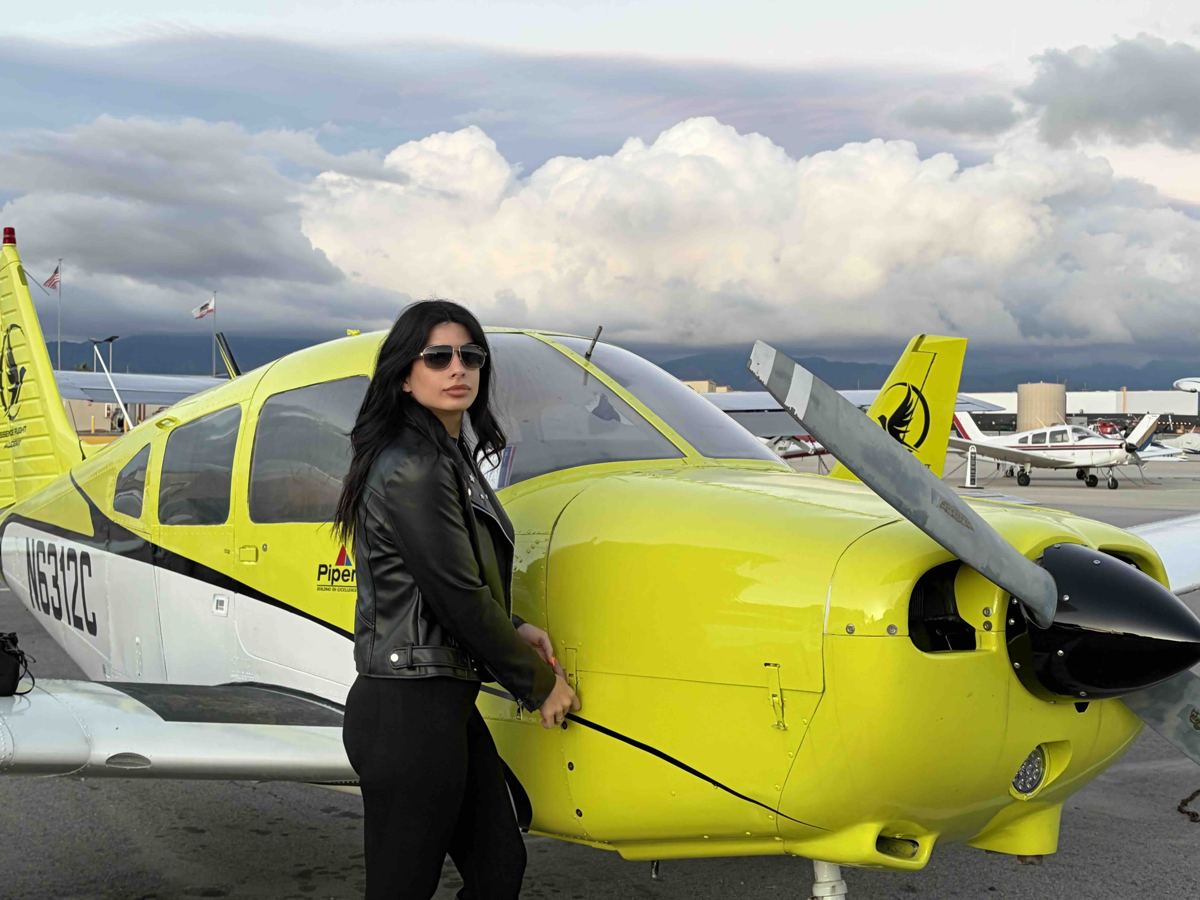 Student pilot and instructor preflighting a Piper Warrior at Van Nuys Airport
