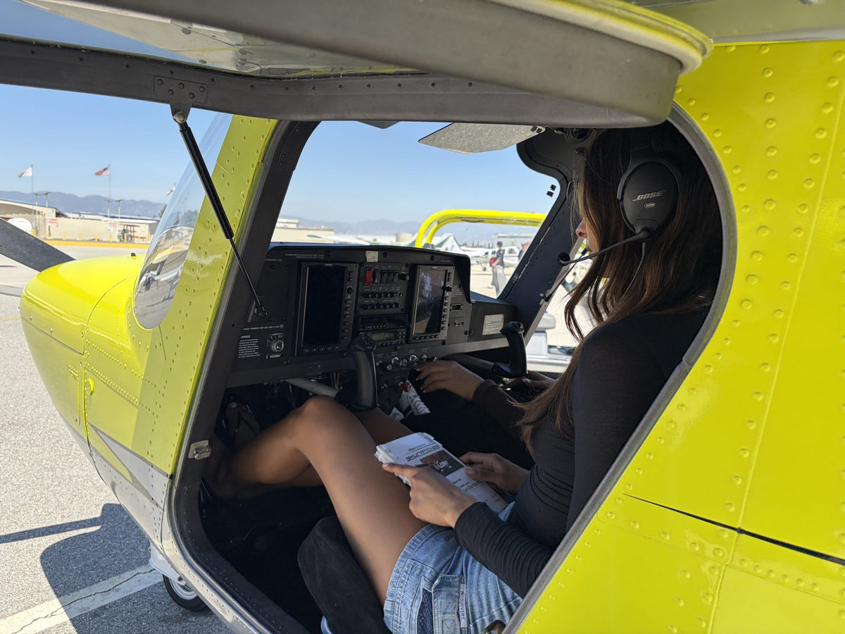 Student pilot reviewing paperwork and a checklist before flight training at Van Nuys