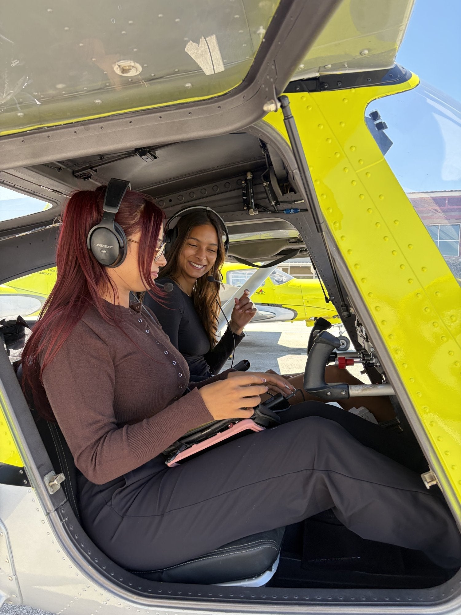 First-time pilot wearing a headset in the left seat during a discovery flight briefing at Van Nuys
