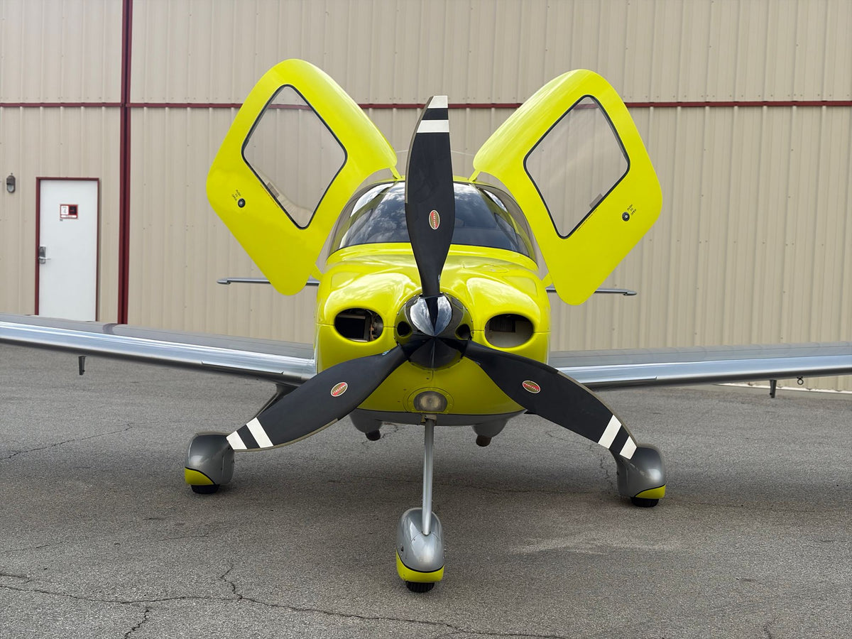A Cirrus SR22 Turbo head-on in the hangar with both doors raised