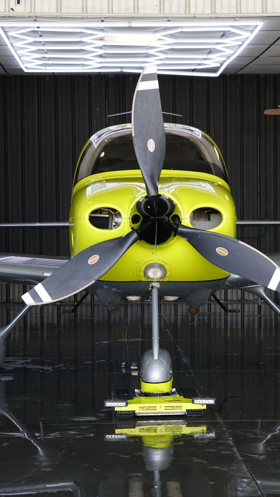 Cirrus SR22 Turbo head-on in the hangar with a floor reflection