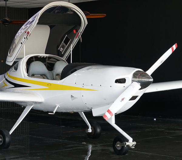 Diamond DA20 with its bubble canopy open in the hangar