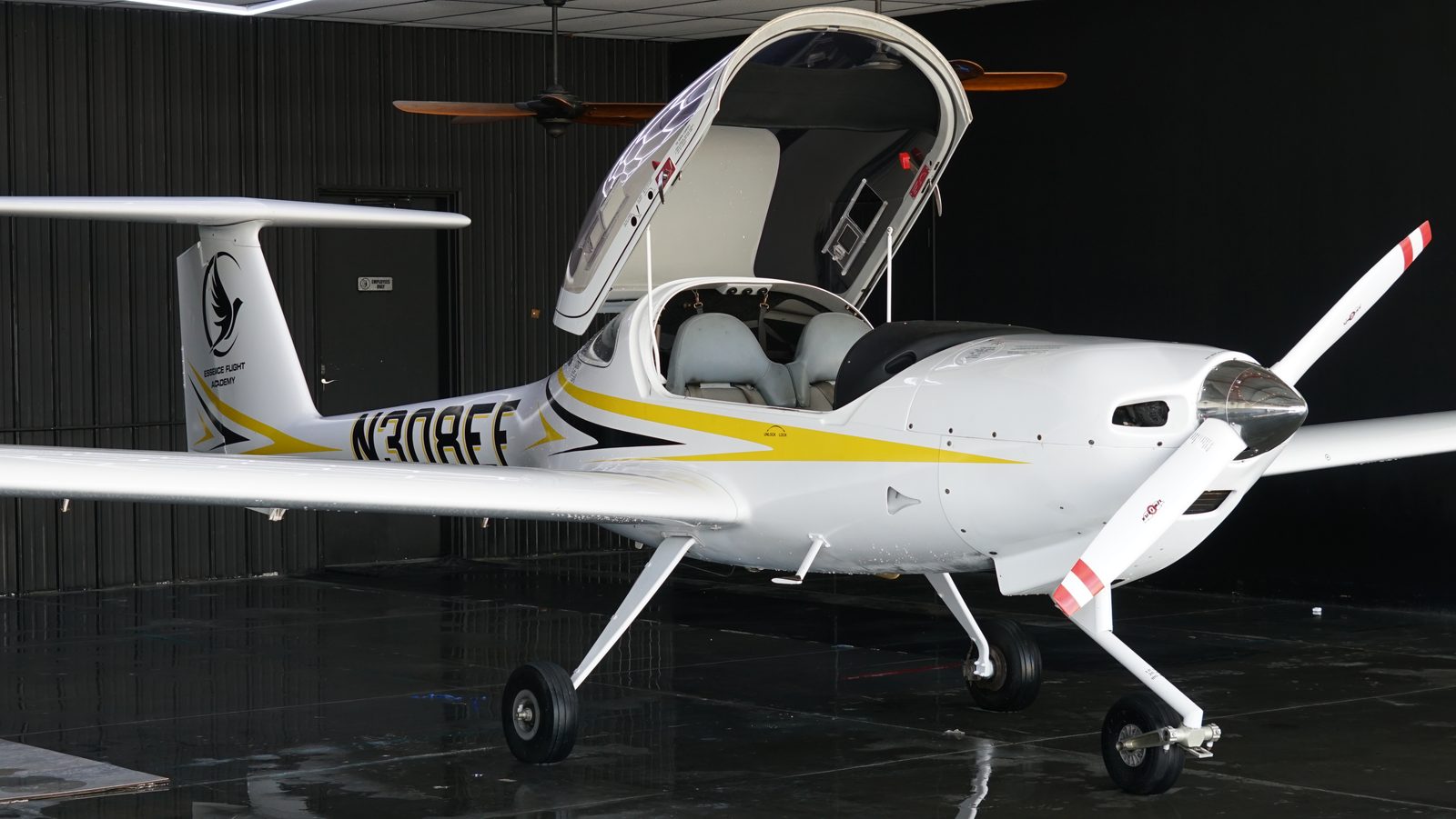 Diamond DA20 with its bubble canopy raised, showing the side-by-side cockpit