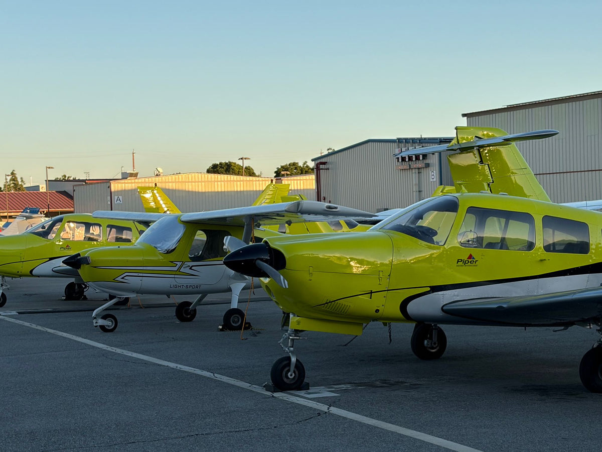 A Piper Warrior, a Cessna 162 and a Piper Seminole lined up on the Van Nuys ramp at sunset