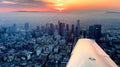 Wing of a training airplane over Los Angeles as evening falls, seen on a night discovery flight for two from Van Nuys