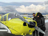 Instructor and student at the nose of a training airplane