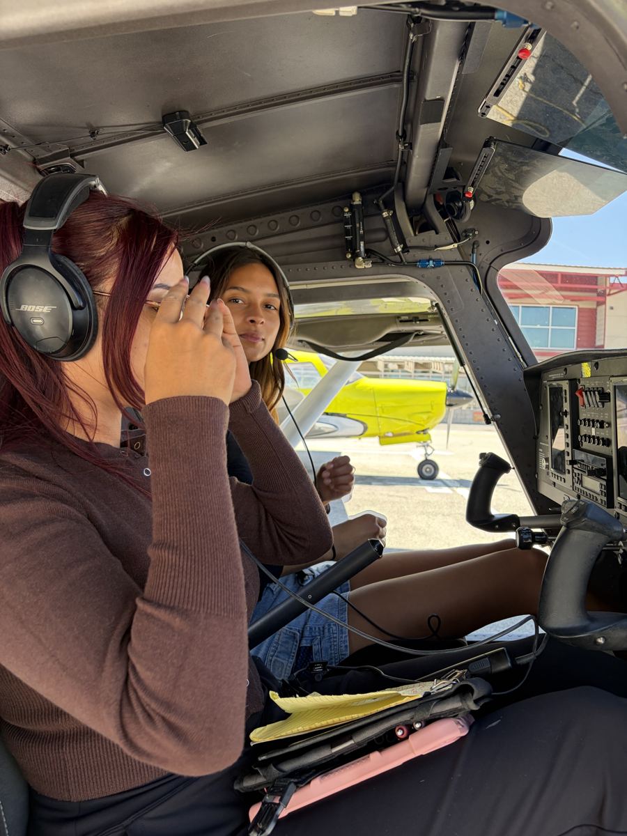 Instructor and student in headsets talking in a training airplane cockpit before a lesson