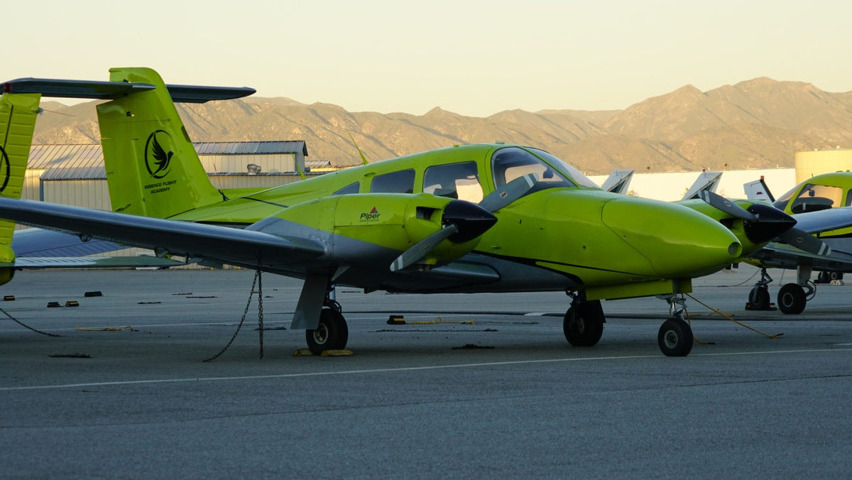 Piper Seminole twin-engine trainer on the Van Nuys ramp with the mountains behind it