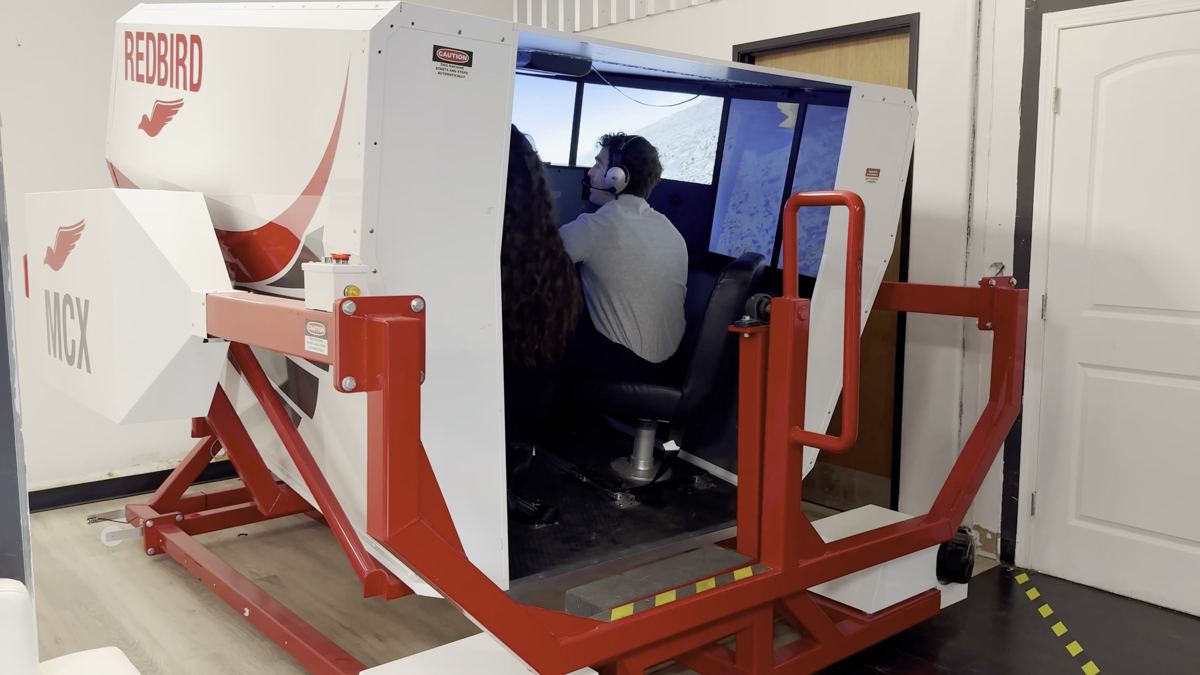 Redbird MCX full-motion flight simulator with a student inside at You Fly LA, Van Nuys Airport